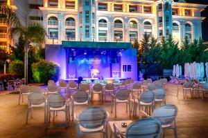 a room with chairs and a stage in front of a building at WELL PALACE SIDE in Side +85 photos