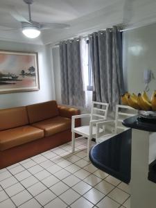 a living room with a couch and a bunch of bananas at Flat na Boa Viagem Recife A in Recife
