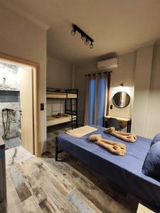 a bedroom with a bed with logs on it at Grecos STAY SKIATHOS in Skiathos Town