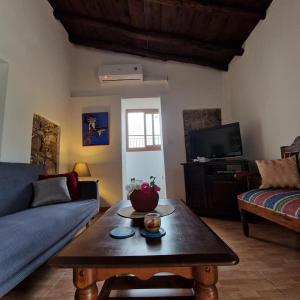 a living room with a couch and a coffee table at THE ROCK HOUSE - Beautiful countryside with mandarins oranges and olive trees,. Near Limassol at Eptagonia village. in Ephtagonia +66 photos