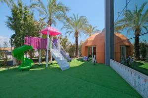 a playground in front of a house with a slide at WELL PALACE SIDE in Side