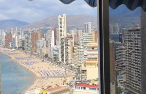 a view of a beach from a window of a city at VERANO AZUL in Benidorm