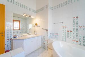 a bathroom with a tub and a toilet and a sink at domo nora in Olbia +47 photos