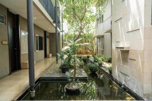 a courtyard with a pond in a building with plants at 3J Home in Binong