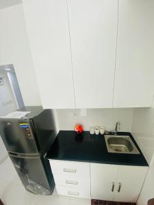 a small kitchen with a sink and a refrigerator at Studio apartment nearby Dhaka airport in Dhaka