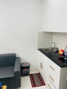 a small kitchen with a sink and a chair at Studio apartment nearby Dhaka airport in Dhaka