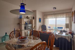 a dining room and living room with a table and chairs at Varandas do Oásis in Figueira da Foz +31 photos