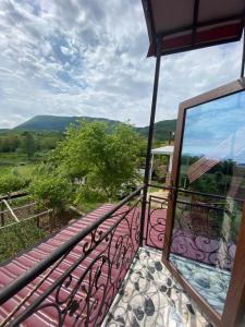 a balcony with a view of a field and mountains at Kirta in Bangveti