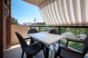 a white table and chairs on a balcony at AT097 Torrepark in Torredembarra