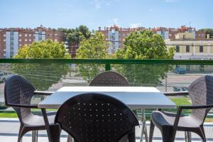 a table and chairs on a balcony with a view of a city at AT097 Torrepark in Torredembarra