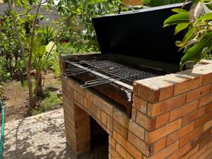 a barbecue grill sitting on top of a brick wall at Blue family villa with large private pool in El-Shaikh Mabrouk