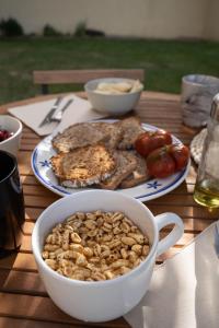 a table with a plate of food and a bowl of nuts at Val de Llous II 39 in Sainte-Léocadie
