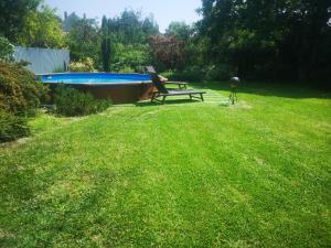 a picnic table in a yard next to a swimming pool at Gere House in Siófok