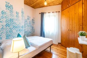 Postel nebo postele na pokoji v ubytování Sleep In Venzone