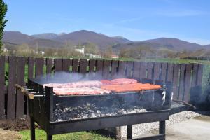 a grill with a bunch of hot dogs on it at Casa Rural Galain Ultzama-Navarra in Lizaso