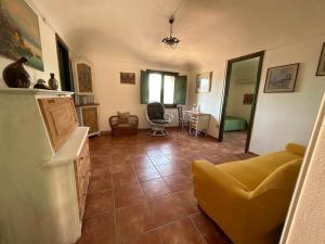 a living room with a yellow couch and a table at La Casa Del Borgo Cavallaro in Gaggi +24 photos