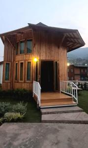 a wooden house with a porch and a deck at Times Klang Sapan Resort 