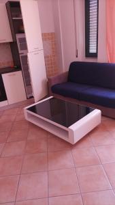 a living room with a couch and a table at Scano Comfort Inn in Santa Teresa Gallura