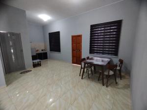 峇株巴辖DAHLIA HOMESTAY Batu Pahat的一间用餐室,在房间内配有桌椅 更多1张照片