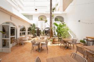 an empty patio with tables and chairs in a building at Hotel Internacional in Benidorm