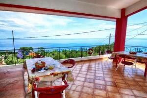 a dining room with a view of the ocean at Ikaria Studios in Manganítis