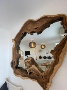 a mirror made out of wood with a living room at Villa Ocean prince in Mikonos +24 photos