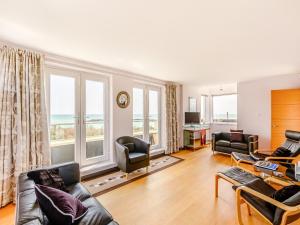 a living room filled with furniture and a large window at Three Decks in Yapton