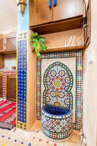 a bathroom with a mosaic tile toilet in a room at Dar Sandra Moroccan Tiny House in Tangier
