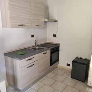 a small kitchen with a sink and a stove at nonna rosa in Reggio Calabria