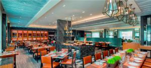 a dining room with tables and chairs in a restaurant at The Raintree, St. Mary’s Road in Chennai