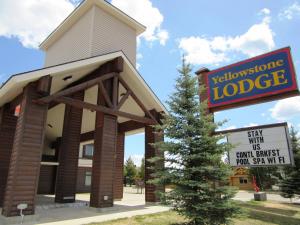 a building with a sign in front of a hotel at Yellowstone Lodge in West Yellowstone