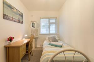 a small bedroom with a desk and a bed and a desk and a bed at Silver Sea in Galway