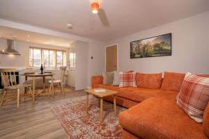 a living room with a couch and a table at Contemporary Home with Parking by LetMeStay in Kendal