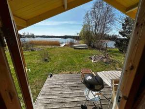 a view from the inside of a porch of a house at Spillersboda stuga med båtar in Spillersboda