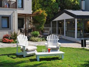 two white chairs and a table in the grass at Dorman Suites in Bitez