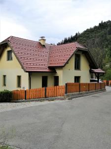 a house with a red roof and a fence at Siesta apartment Bled in Bled