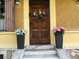 eine Holztür mit zwei Vasen mit Blumen darauf in der Unterkunft Historische Villa Velden im Zentrum in Velden am Wörthersee