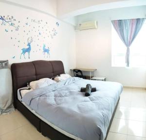 a bedroom with a large bed with aokedokedokedoked at Comfy Home Near to SPICE and USM in Bayan Lepas