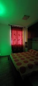 a bedroom with a bed and a red curtain at Casa Sartiglia in Oristano