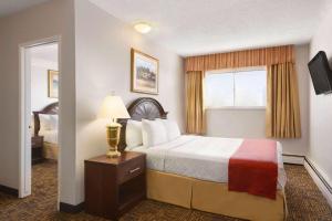 a hotel room with a bed and a window at Travelodge by Wyndham North Battleford in North Battleford