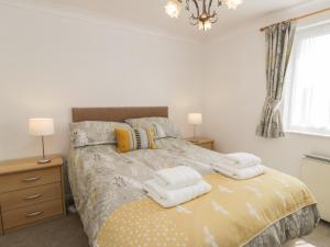 a bedroom with a bed with towels on it at 25 South Snowdon Wharf in Porthmadog
