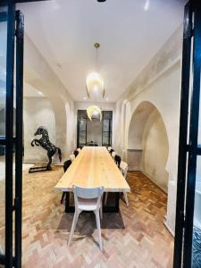 a large conference room with a table and a dinosaur statue at Riad Zhor Tanger - Médina in Tangier