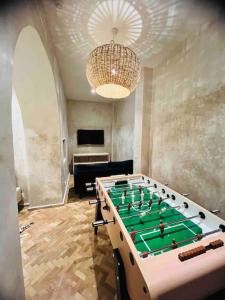 a room with a pool table and a chandelier at Riad Zhor Tanger - Médina in Tangier