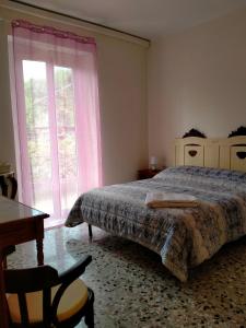 a bedroom with a bed and a large window at Affittacamere DA MARIA TERESA in Sestri Levante