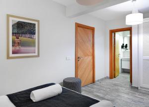 a bedroom with a bed and a wooden door at Dorman Suites in Bitez