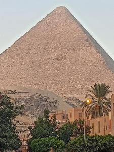 a view of the pyramids of egypt with a street light in front at Big , Pyramid view in Cairo