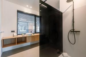 a bathroom with a shower and a sink at House K in Kortrijk