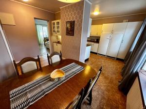 a kitchen and dining room with a wooden table and chairs at Ljungaverk trerummare 90kvm in Ljungaverk