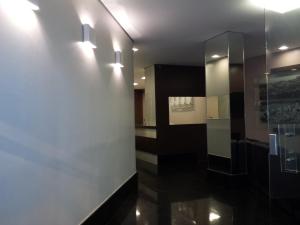 a hallway with lights on the wall at Fenicia Palace Hotel in Varginha
