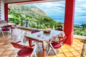 a balcony with a table and chairs with a view at Ikaria Studios in Manganítis